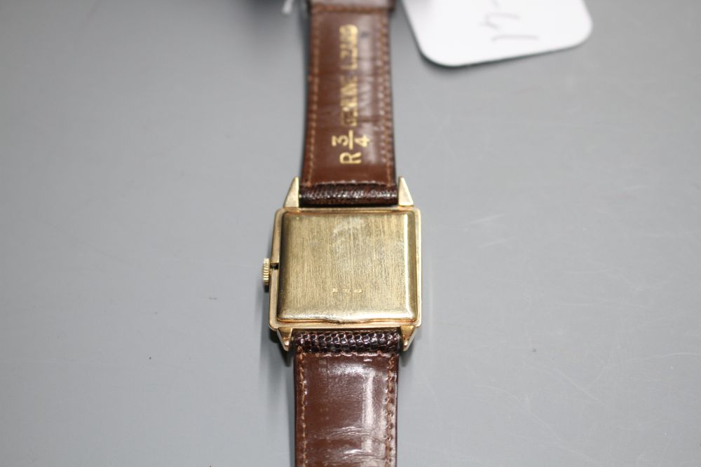 A gentlemans 1950s? 14k Jules Jurgensen manual wind wrist watch, with square tumbling Roman dial,